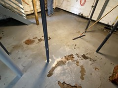 This basement floor had cracks and damage from years of wear and tear
