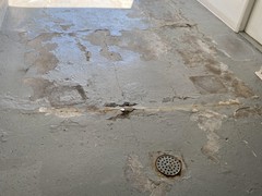 This garage floor shows significant spalling and crumbling.