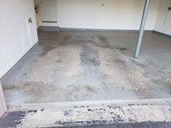 Another view of the garage floor showing the same issues.