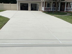 The Finished Product!  We filled the expansion joints with urethane; applied polymer resurfacer to the entire driveway and finished the project with a coat of Concrete Guard.
