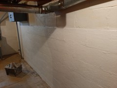Next we applied primer and the liquid rubber to the walls, creating a moisture barrier. You can see the vast difference here.