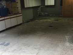 This garage floor needing power washing, crack repair, and resurfacing. The surface was finished with a skim coat of resurfacer.