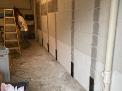 Our crew grinded the wall where the stabilizing straps will be located.  The bottom anchors were installed.