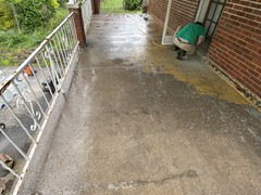 Before pictures of a porch patio and set of steps we power washed, repaired, resurfaced, applied primer, and (2) coats of elastomeric Saf-T-Dek grey paint.